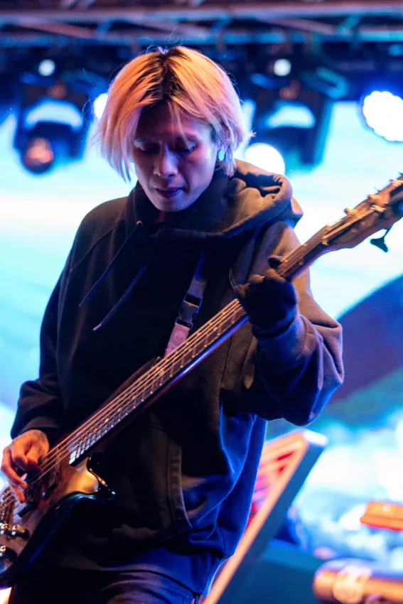 Close view of a guitarist performing beside the LED screen at Paragon Club, Cheras